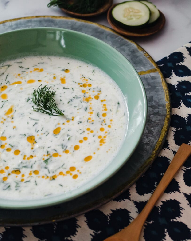 Cold Cucumber Yogurt Soup in a bowl with the bowl cut in half