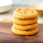 four cookies stacked on wooden plate
