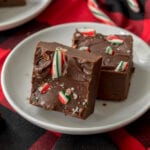 two pieces of candy cane fudge on a white plate