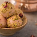 rose truffles rolled in pistachios in a small bowl